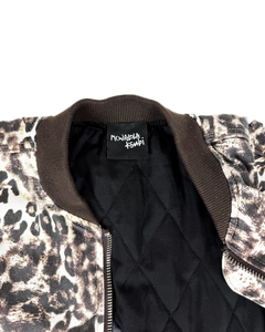 Cheetah-print bomber jacket interior with black quilted lining and neck label