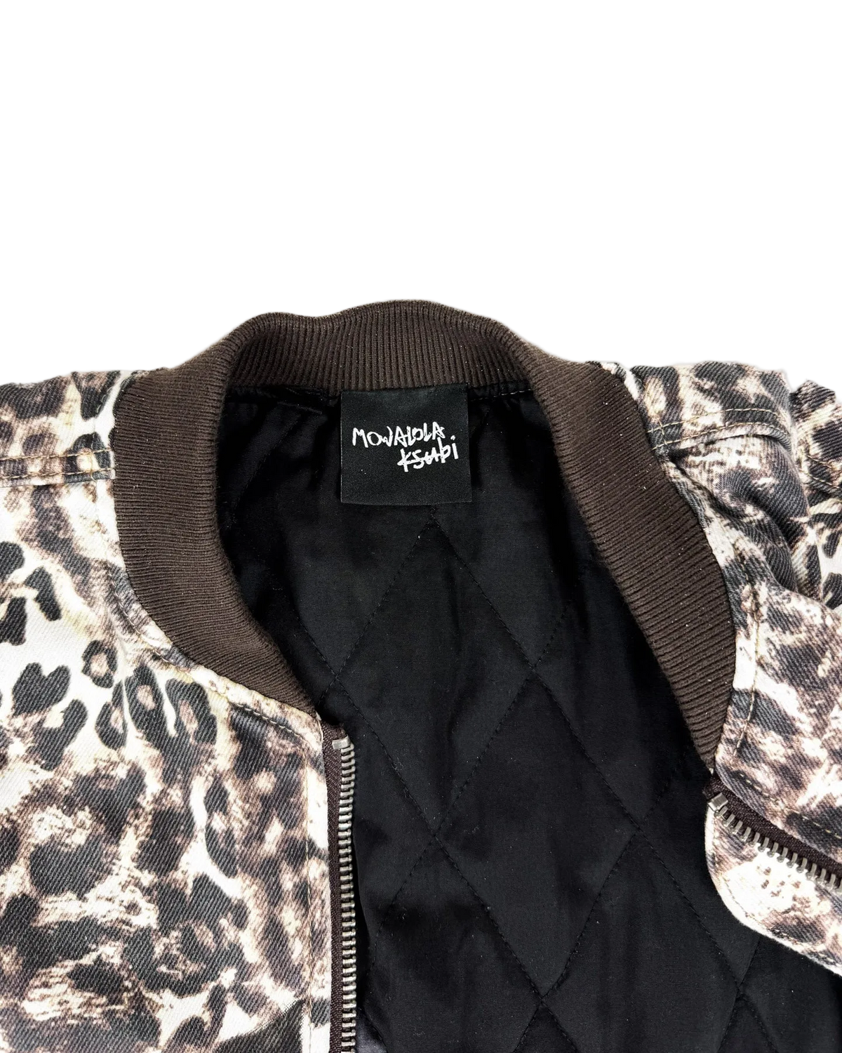 Cheetah-print bomber jacket interior with black quilted lining and neck label