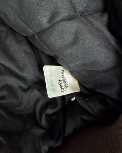 Black bomber jacket lining with woven size/brand label tag